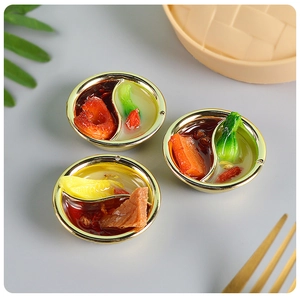 Macro detail of miniature hot pot food models with intricate ingredients and golden trim