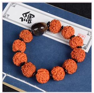 Macro detail of Rudraksha seed bracelet with tortoise shell patterned agate bead