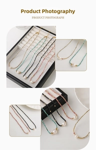 Close-up of colorful beaded necklaces with natural pearls and golden lobster clasps