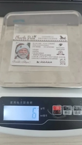 Macro shot showing 6g weight of Santa Claus North Pole sled drivers license card
