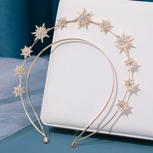 Baroque gold double-layered headband with sparkling crystal stars on a display stand