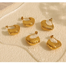 Macro shot of 18K gold plated C-shaped earrings with unique frosted bubble texture
