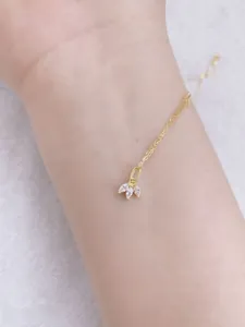 Detailed close-up of a delicate gold S925 silver necklace with three marquise-cut zircons