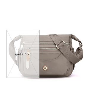 Waterproof nylon crossbody bag in mud grey color shown with 9.7 inch iPad size comparison