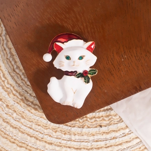 Cute white cat Christmas brooch with red Santa hat and holly leaves with rhinestones