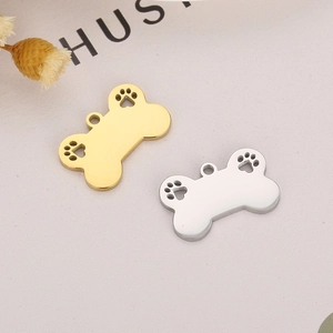 Gold and silver hollow dog bone pendants with paw print cutouts for DIY pet tags