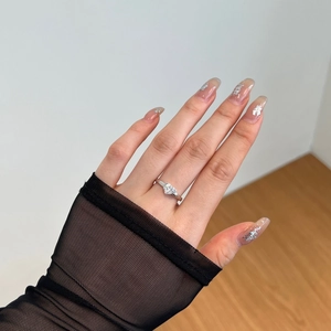Close-up of elegant S925 silver heart ring with sparkling ice flower zircon on hand