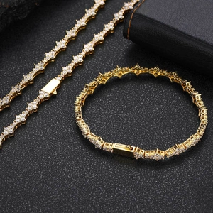 Macro shot of gold plated tennis chain necklace and bracelet set with cubic zirconia stones