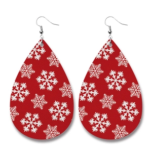 Faux leather teardrop earrings with festive red base and white snowflake patterns