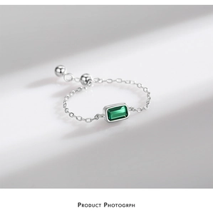 Detailed macro view of S925 silver chain ring with emerald-green rectangle zircon