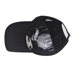 Top view of a black cotton baseball cap interior showing the 100% cotton wash label
