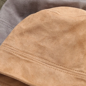 Detailed close-up of faux suede fabric with precise double stitching on the bucket hat brim