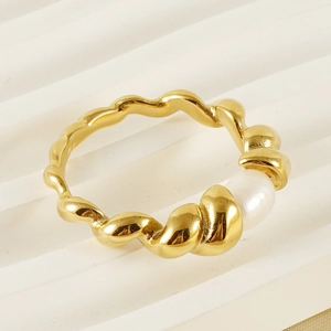 Minimalist 18k gold plated stainless steel ring with natural white pearl on a white surface