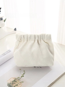 Detail of soft cream corduroy mini pouch texture with high quality elastic closure