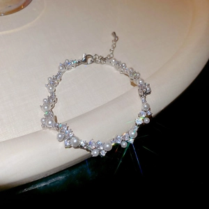Macro shot of sparkling zircon pavé and pearls on an irregular wrap bracelet design