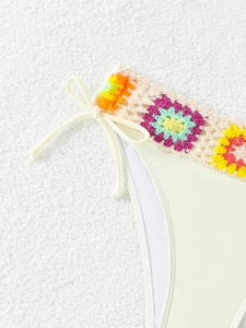 Detail of off-white bikini bottom with colorful crochet waist and side tie bows