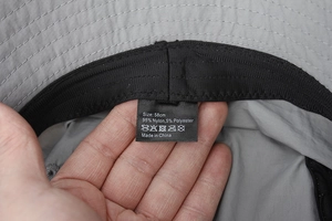 Detail of grey sun hat inner lining showing sweatband and material care label