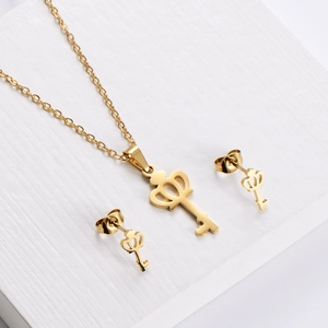 Golden titanium steel jewelry set featuring crown and key pendant necklace and stud earrings