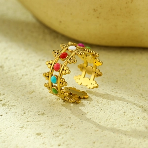 Macro shot of 18K gold plated hollow ring featuring colorful enamel and stone inlays