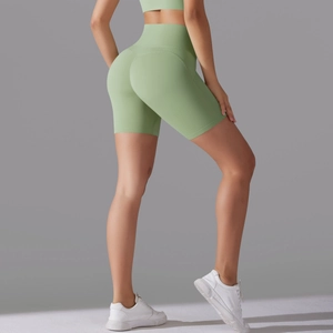 Macro view of high-waisted light green yoga shorts with seamless contouring design