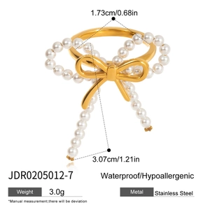 Detailed size specifications for a gold stainless steel bow ring with pearl accents