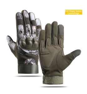 Detail of green camo tactical gloves with hard knuckle protection and touchscreen fingertips