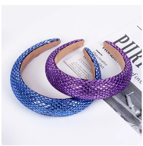 Close-up of blue and purple rhinestone headbands with sparkling baroque sponge padding