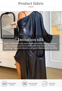 Detail view of smooth black satin robe back showing premium texture and fluid drape