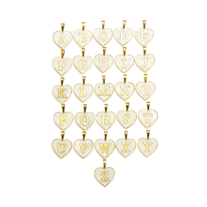 Macro view of gold heart pendants with pearl white A-Z shell letter inlay accessories