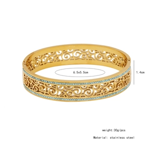 Detail showing dimensions of vintage gold hollow cuff bracelet with blue rhinestones