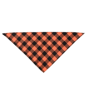 Detailed view of orange and black plaid cotton dog bandana with woven fabric texture