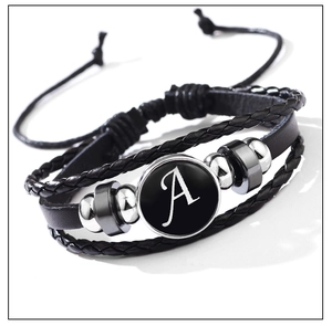 Close-up of a multilayer braided black leather bracelet with a glass letter A charm