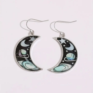 Macro shot of celestial moon crescent earrings with aurora star and planet patterns