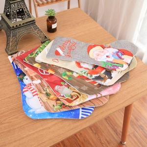 Detail of Christmas stockings with Santa and snowman patterns on a wooden table