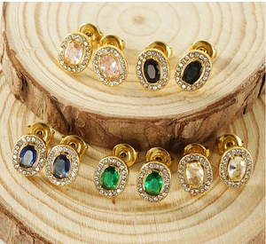 Detailed close-up of gold stainless steel halo stud earrings with colorful oval zircon stones