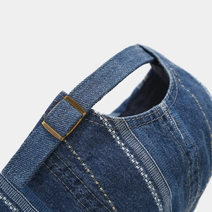 Vintage navy denim newsboy cap with adjustable bronze buckle and pinstripe texture