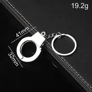 Mini silver metal handcuffs keychain with dimensions 41x32mm and 19.2g weight