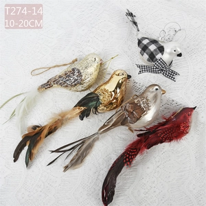 Detailed view of hand-painted bird ornaments with feathers and glitter for Christmas trees