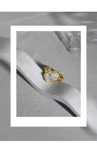 Detailed macro shot of a golden foil-textured S925 silver ring with a large zircon stone