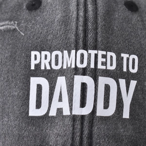 Dark grey washed cotton baseball cap with Promoted to Daddy white printed lettering