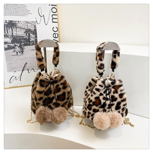Close-up of leopard faux fur bucket bag with golden chain and plush pom-poms