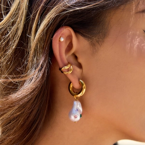 Golden titanium steel earring set with baroque pearl charms and colorful stones on model