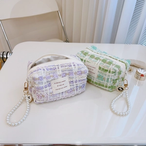Elegant tweed mini handbag with gold zipper and pearl handle in lavender and light green