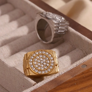 Macro shot of gold and silver hip hop rings with micro-pave crystals in a jewelry box
