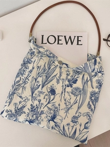 Blue floral porcelain print cotton shoulder bag with brown leather handles and magnetic snap