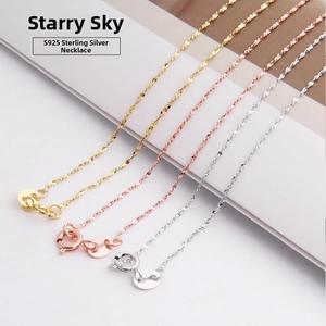Close-up of S925 sterling silver star chain necklaces in gold, rose gold and silver