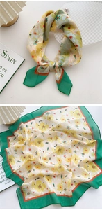 Detail of floral cotton linen scarf featuring yellow petals and green borders in layout