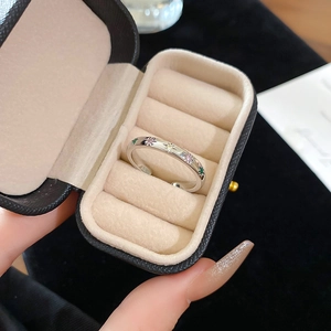 Detail of silver rings with colorful zircon inlay presented in a luxury jewelry box