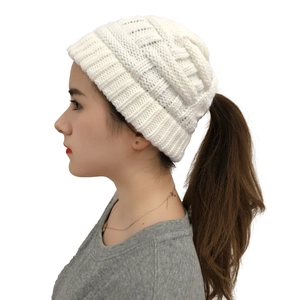 Close-up side view of white cable knit beanie featuring a convenient ponytail hole design