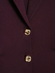 Macro detail of dark purple knit top featuring unique golden organic-shaped metal buttons